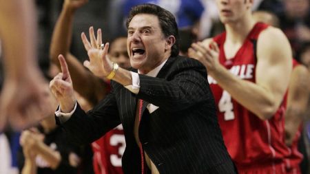 Rick Pitino in a black suit while coaching the game.